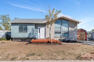 View of front of house with a storage shed | Image 1