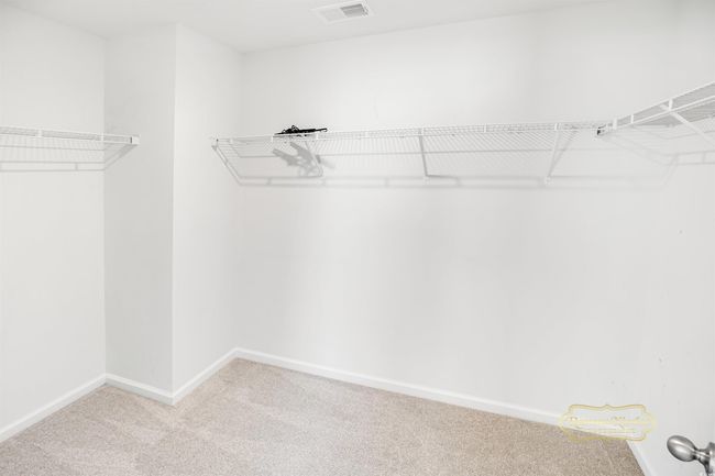 Spacious closet with carpet floors | Image 21