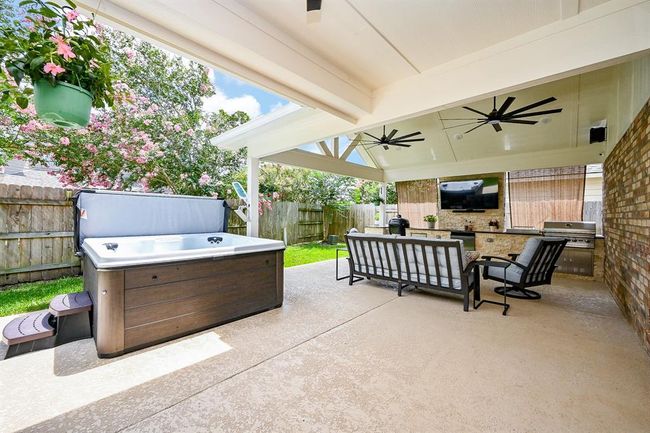 This photo showcases a beautifully designed covered outdoor living space, perfect for relaxation and entertaining. | Image 4