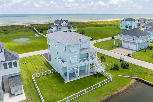 Enjoy the fenced backyard, the pond and amazing sunset views from the rear of the home | Image 5