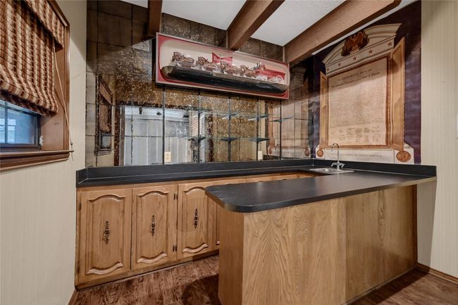 Bar featuring dark wood-style floors, a sink, and wet bar | Image 13