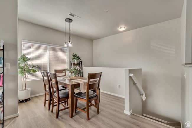 Dining space featuring visible vents, light wood-style flooring, and baseboards | Image 5