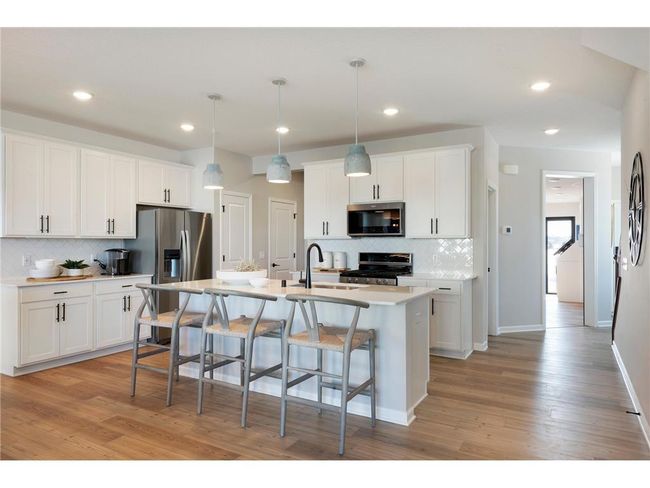 The Ashton also features modern white cabinets that complement the stainless-steel appliances perfectly! Photo of model home. | Image 35