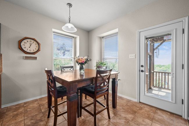 The dining area is perfectly situated with an abundance of natural light and direct access to the outdoors. | Image 9