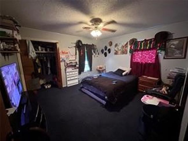 Bedroom featuring a textured ceiling, a closet, and a ceiling fan | Image 10