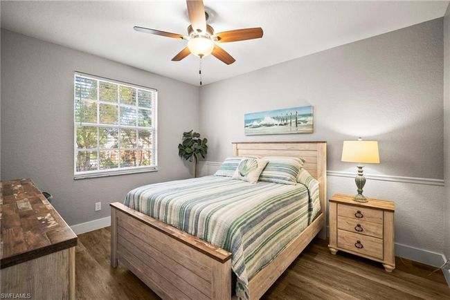 Bedroom with baseboards, ceiling fan, and dark wood finished floors | Image 16