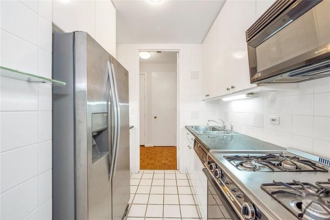 Kitchen with door to entry Foyer | Image 5