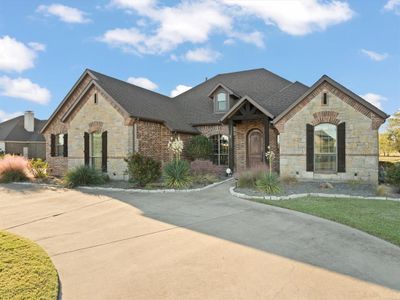 A gorgeous curb appeal with circle drive and stone and brick elevation welcome you inside. | Image 3