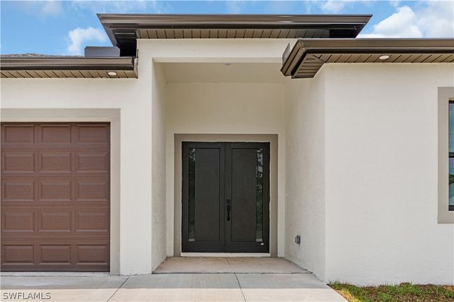 Property entrance with a garage | Image 8