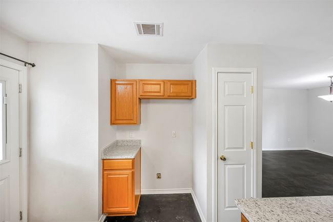 Kitchen featuring baseboards and light stone countertops | Image 15