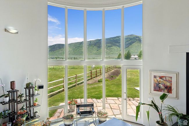 Sunroom featuring a mountain view and plenty of natural light | Image 15