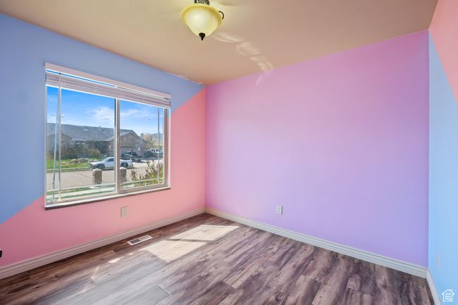 Unfurnished room featuring baseboards, visible vents, and wood finished floors | Image 15