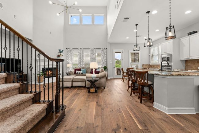 Bright and airy with natural light pouring in through large windows, this open-concept layout seamlessly connects the living room, dining area, and gourmet kitchen. Perfect for entertaining or family gatherings, with hardwood floors, high ceilings, and stylish finishes throughout. | Image 5