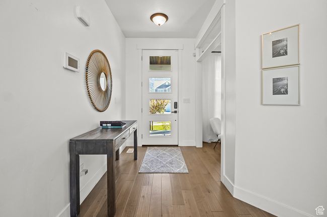 Entrance foyer featuring baseboards and wood finished floors | Image 5