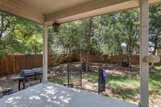 Fenced backyard featuring a patio area and a gate | Image 34