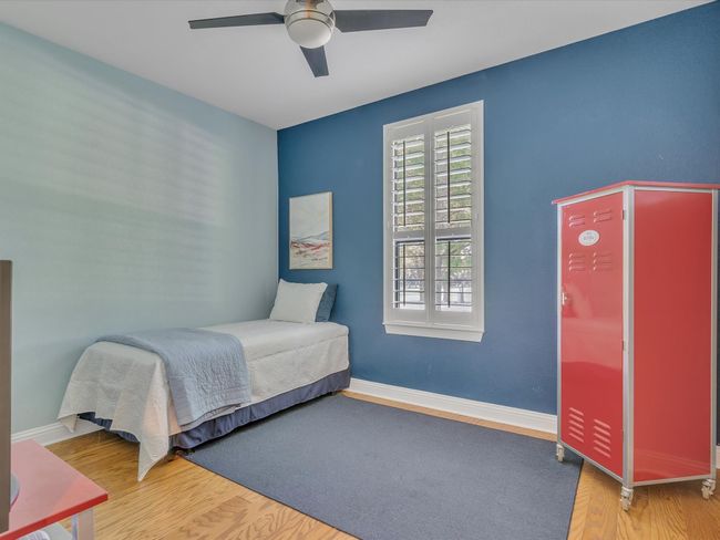 Bedroom featuring wood finished floors, baseboards, and a ceiling fan | Image 28