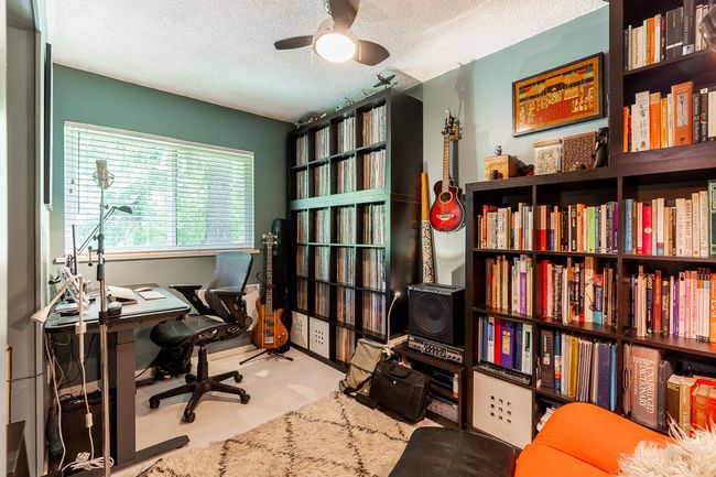 Office space featuring a ceiling fan and a textured ceiling | Image 16