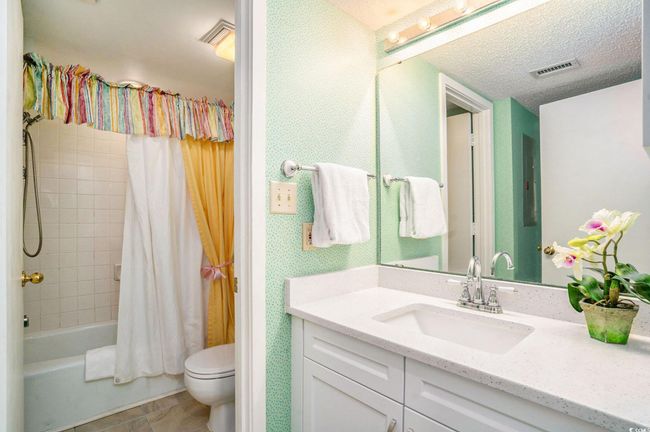 Full bath featuring vanity, comfort station, and shower / bath combo lock off. | Image 16