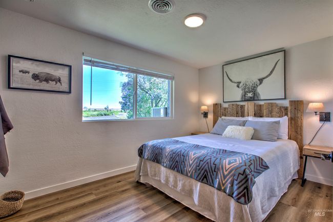 Bedroom featuring wood finished floors and baseboards | Image 19