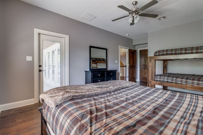 Bedroom with dark hardwood / wood-style floors and ceiling fan | Image 23