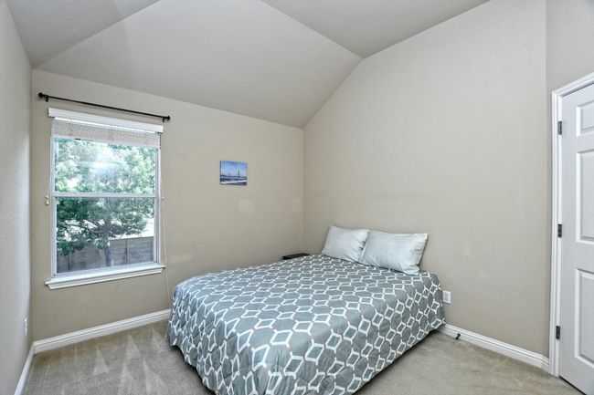Bedroom featuring vaulted ceiling, carpet floors, and baseboards | Image 25