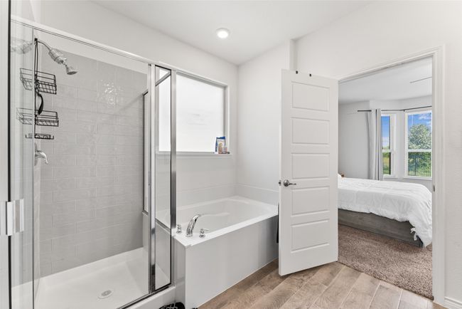 Bathroom with a shower stall, a bath, wood finished floors, and connected bathroom | Image 17