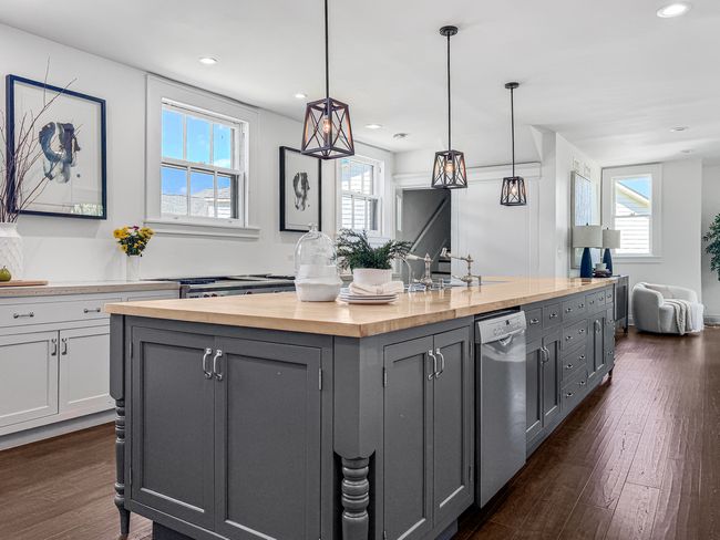 This bright, open-concept kitchen features a massi | Image 20