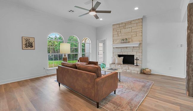 Living area with wood finished floors, ceiling fan, baseboards, visible vents, and recessed lighting | Image 8