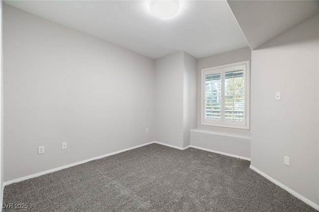 Unfurnished room featuring baseboards and dark colored carpet | Image 22