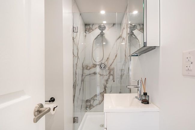 Full bath with a marble finish shower, vanity, and recessed lighting | Image 13