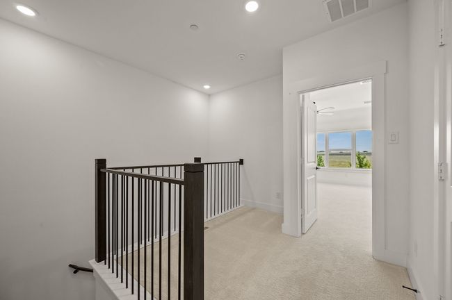 The loft at the top of the stairs makes a perfect pocket office or reading nook. | Image 11