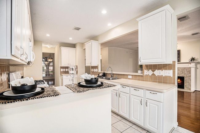 Open countertop bar looking into the living room. | Image 18