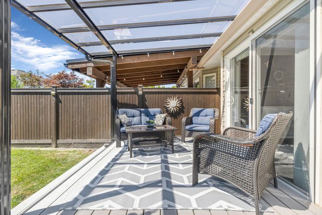 Deck with an outdoor living space and fence | Image 26
