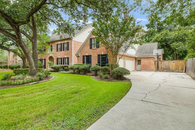 The side-entry three-car garage adds both functionality and curb appeal, offering plenty of space for vehicles, storage, or weekend projects—plus extra room for guests to park with ease. | Image 6