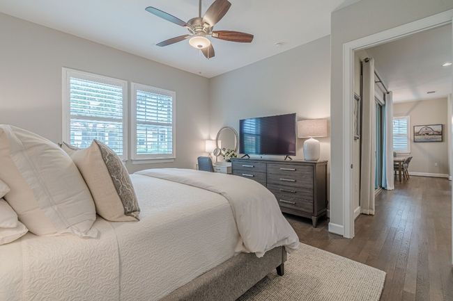 Bedroom featuring dark wood-style flooring, baseboards, and ceiling fan | Image 27