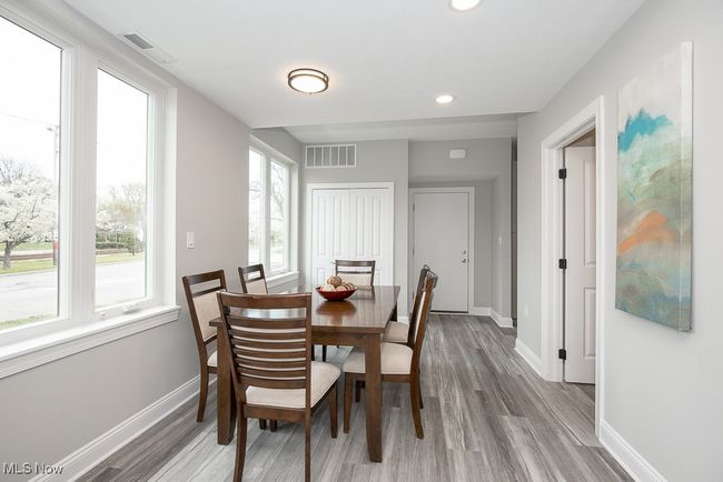 Dining space with a healthy amount of sunlight and light hardwood / wood-style flooring | Image 12