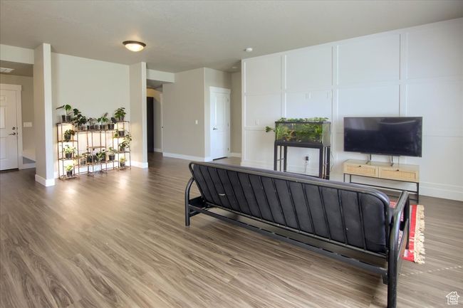 Interior space featuring wood finished floors, baseboards, and visible vents | Image 5