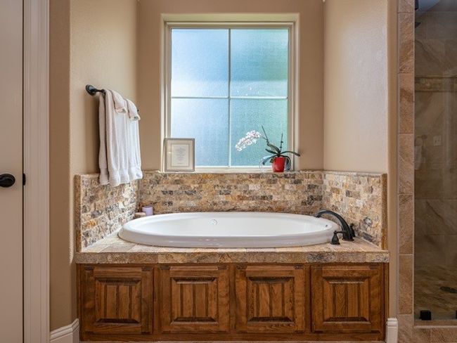 Full bathroom featuring a garden tub and a stall shower | Image 21