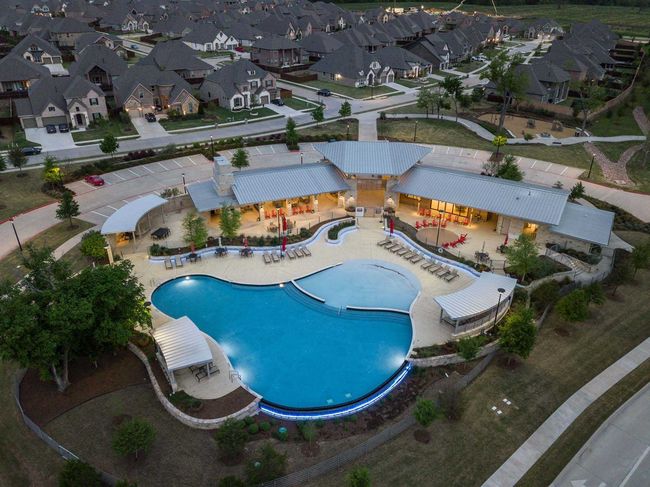 Aerial view of property and surrounding area with a pool area and nearby suburban area | Image 38