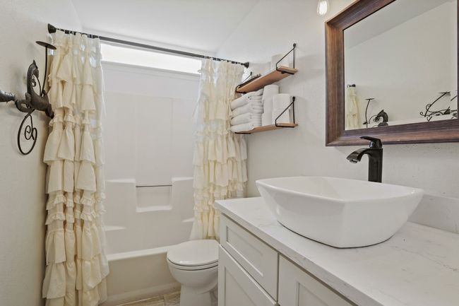 Full bathroom featuring vanity and shower / bath combo. | Image 11