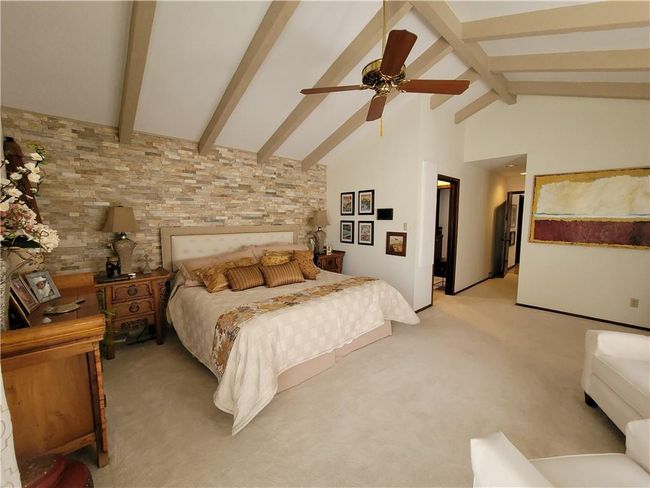 Bedroom with light carpet, high vaulted ceiling, beamed ceiling, and ceiling fan | Image 24
