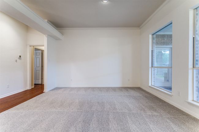 Formal Living/Dining area with new carpet and paint, crown molding and natural light. | Image 5