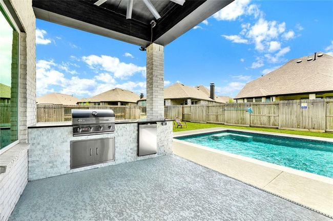 Custom outdoor kitchen with gas grill and beverage fridge | Image 7