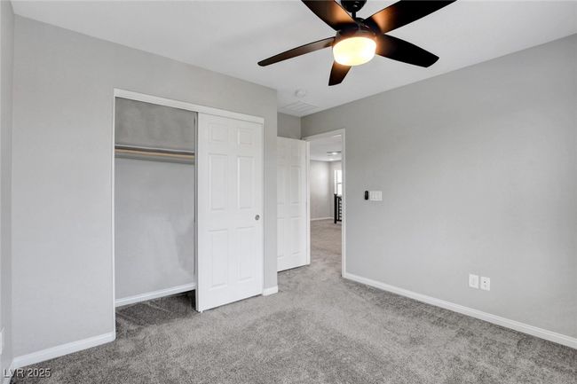 Unfurnished bedroom with carpet flooring, baseboards, a closet, and a ceiling fan | Image 32