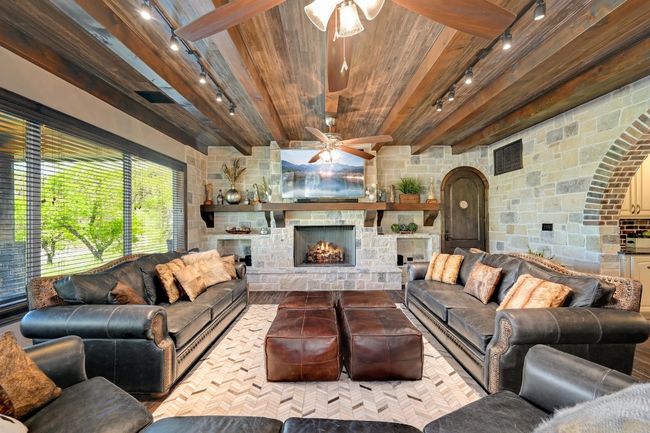 Living room featuring visible vents, ceiling fan, rail lighting, and wood ceiling | Image 14