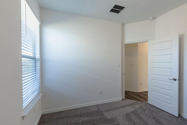 Carpeted empty room featuring visible vents, baseboards, and a healthy amount of sunlight | Image 21
