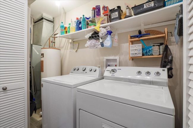 Laundry room featuring washing machine and clothes dryer | Image 14