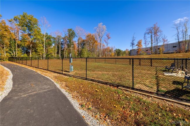 View of community featuring a yard and fence | Image 22