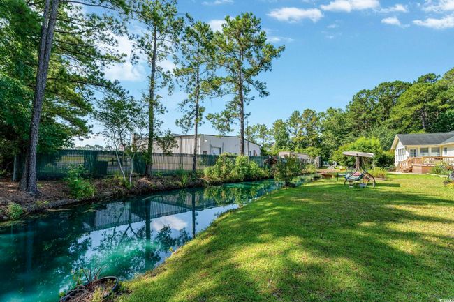 View of yard with a wooden deck | Image 25