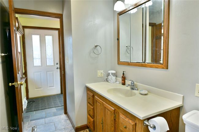 Bathroom featuring baseboards, toilet, and vanity | Image 41
